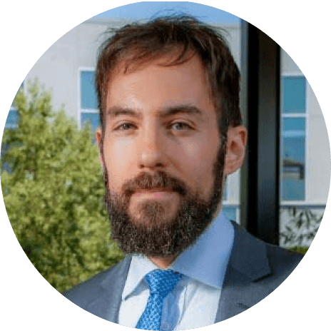 Professional looking university professor with beard wears a suit and blue tie